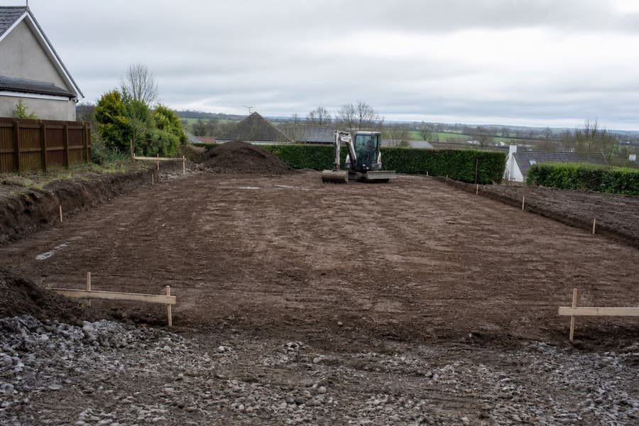 Cleared and levelled residential building plot with survey pegs
